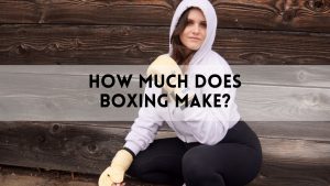 Woman in boxing gloves and hoodie kneeling outdoors, with text overlay that reads “How Much Does Boxing Make?”—highlighting the main keyword.