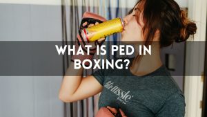 Female boxer in training gear drinking from a can, with text overlay that reads “What Is PED in Boxing?”—featuring the main keyword.